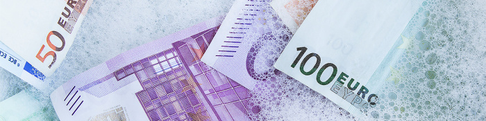 Bild zeigt Geldscheine, die in einem Schaumbad gebadet werden. 